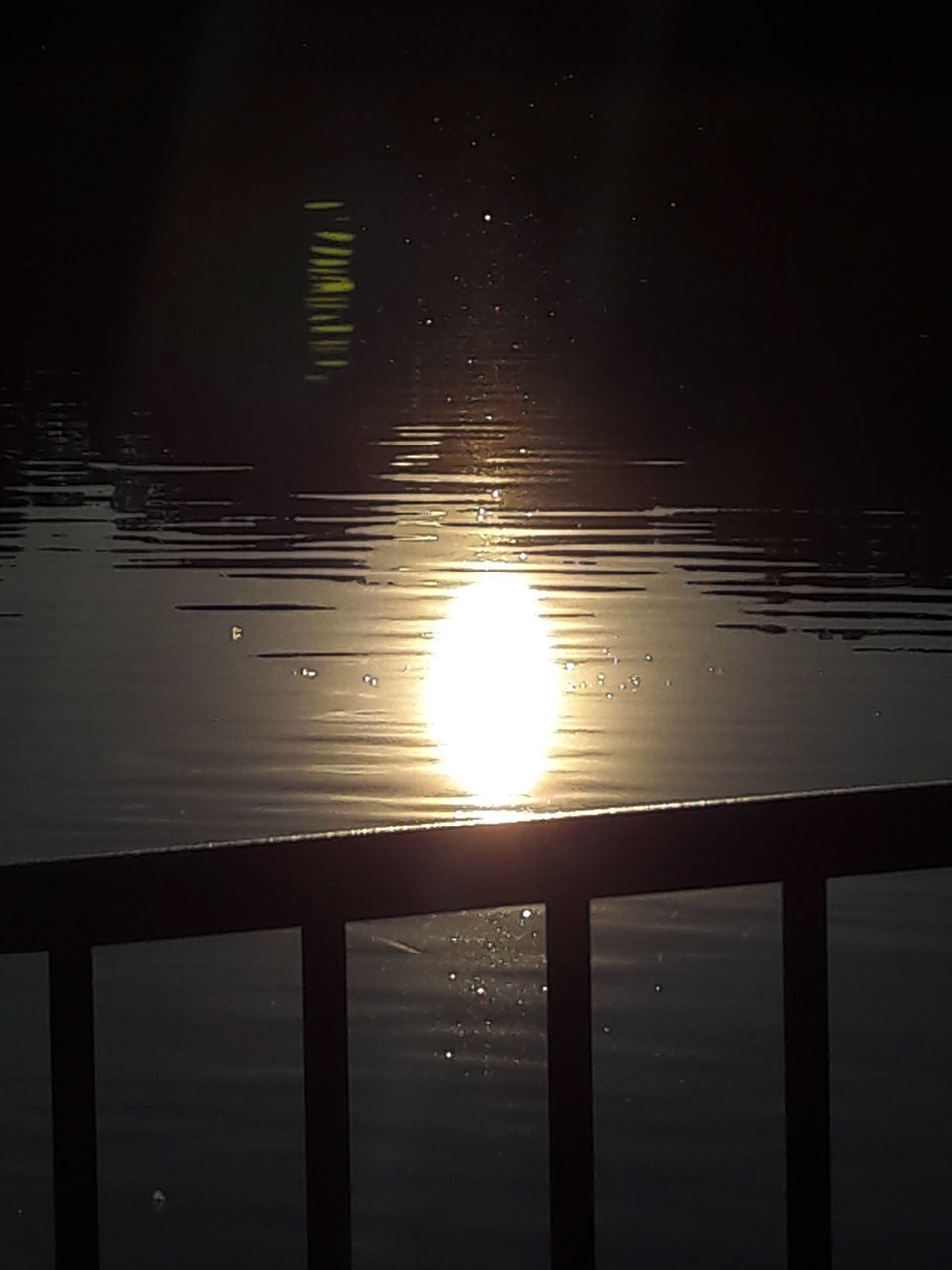 SUN SHINING OVER LAKE DURING SUNSET