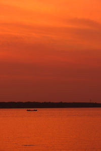 Scenic view of sea against romantic sky at sunset