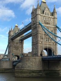 View of bridge over river against cloudy sky