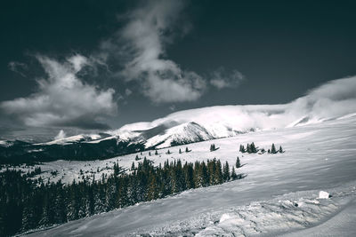 Scenic view of snowcapped mountains against sky