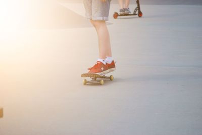 Low section of person on skateboarding on park