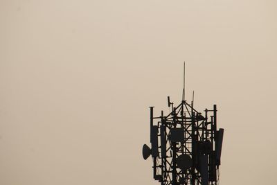 Low angle view of silhouette tower against clear sky during sunset