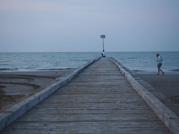 Scenic view of pier on sea against sky