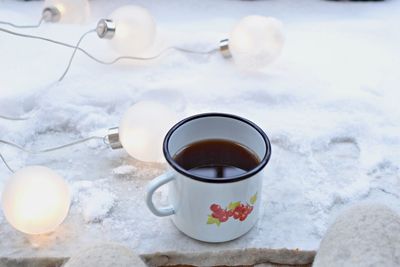 High angle view of coffee cup in snow