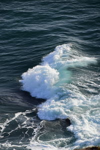 High angle view of waves rushing towards shore