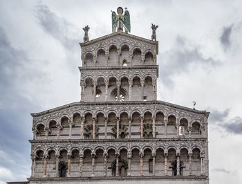 Low angle view of historical building against cloudy sky