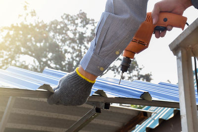 Low section of man standing by railing