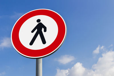 Low angle view of road sign against sky