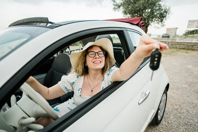 Portrait of smiling woman in car