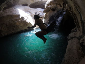 Man swimming in cave