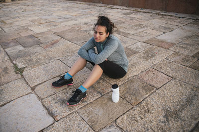 Tired woman sitting after exercise