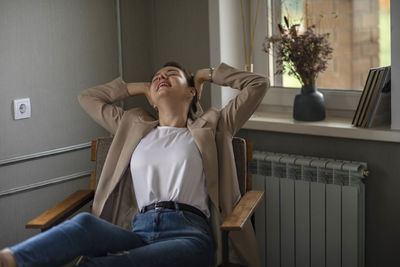 Stretching serenity, serene break captured as young manager enjoys moment of relaxation, stretching