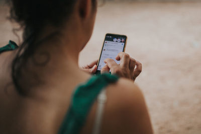 Rear view of woman using phone