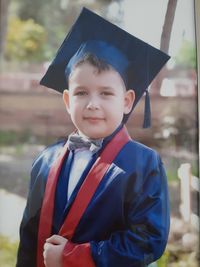 Portrait of smiling boy graduation gown