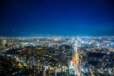 Aerial view of illuminated city buildings at night