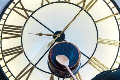 Low angle view of clock tower against ceiling