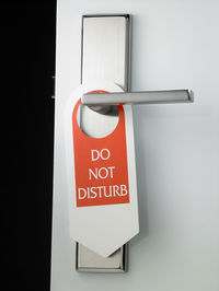 Close-up of do not disturb sign hanging on door handle