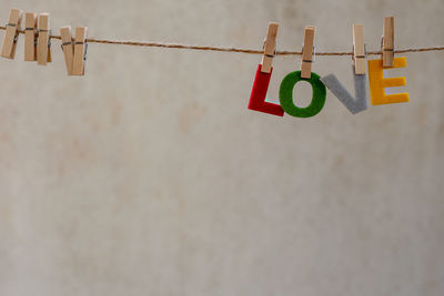 Close-up of clothespins hanging on rope