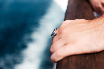 Cropped hand of man holding pocket watch