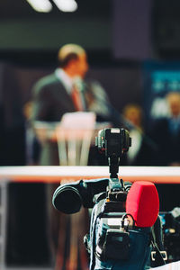 Close-up of video camera against people