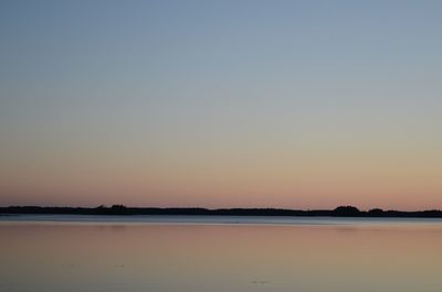 Scenic view of sea against clear sky during sunset