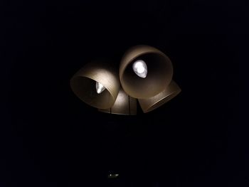 Close-up of illuminated lamp against black background