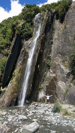 Scenic view of waterfall against sky