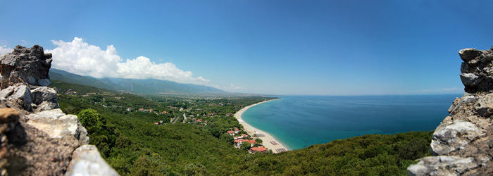 Panoramic view of sea and mountains against sky