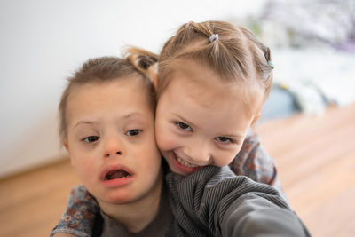 High angle view of mother carrying daughter at home