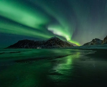 Scenic view of snowcapped mountains against sky at night