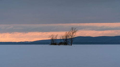 Scenic view of snow against sky during sunset