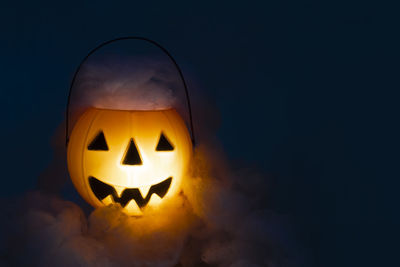 View of illuminated pumpkin against black background