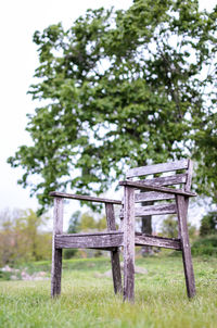 Empty chairs and table on field