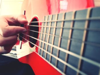 Close-up of hand playing guitar