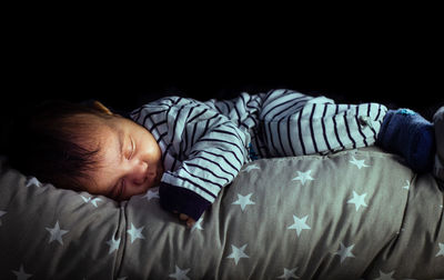 Boy sleeping on bed