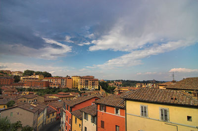 Houses in city against sky