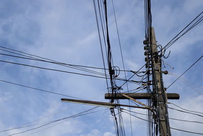 Low angle view of electricity pylon against sky