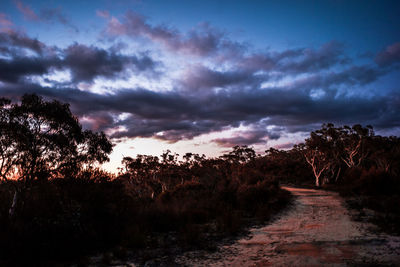 Empty road against cloudy sky