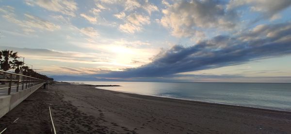 Scenic view of beach against sky during sunset