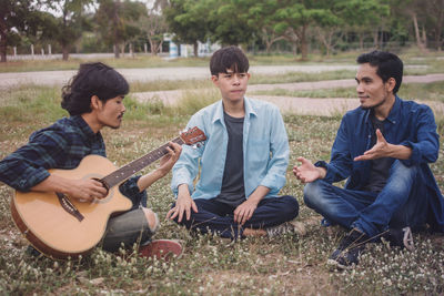 People playing guitar on field