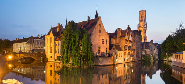 Reflection of buildings in city at waterfront