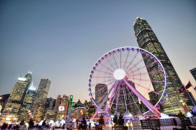 Low angle view of illuminated ferris wheel against sky at night