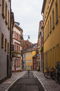 Street amidst buildings against sky