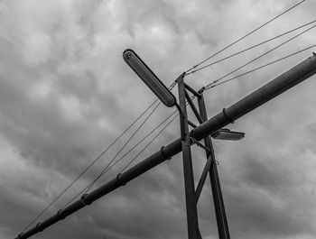 Low angle view of electricity pylon against sky