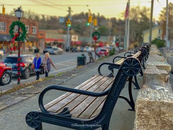 Close-up of empty bench on road