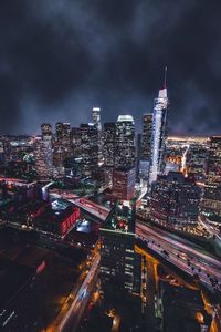 Illuminated cityscape against sky at night