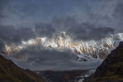 Low angle view of storm clouds over mountain