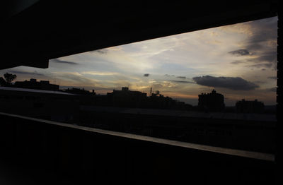 Clouds over city at sunset