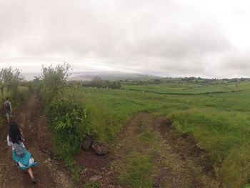 Scenic view of landscape against cloudy sky