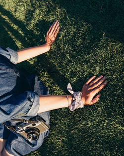 High angle view of woman hand on field